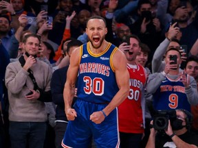 Warriors guard Stephen Curry reacts after a three-point basket, breaking the career record for total three pointers made  in the NBA, during the first quarter against the Knicks at Madison Square Garden in New York City, Tuesday, Dec. 14, 2021.