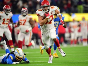 Kansas City Chiefs tight end Travis Kelce runs the ball for a touchdown ahead of Los Angeles Chargers defensive back Trey Marshall during overtime at SoFi Stadium in Inglewood, Calif., Dec. 16, 2021.