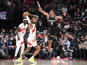 Raptors' Gary Trent Jr. looks to make a pass as Sacramento Kings' Tyrese Haliburton defends during the first half at Scotiabank Arena on Monsday, Dec. 13, 2021.