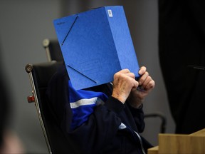 A 101-year-old former security guard of the Sachsenhausen concentration camp appears in the courtroom before his trial at the Landgericht Neuruppin court, Brandenburg, Germany, Dec. 2, 2021.
