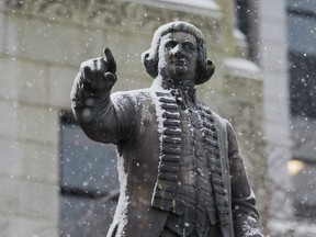 The Captain George Vancouver statue at Vancouver City Hall receives a dusting of snow in this Dec. 9, 2016 file photo.