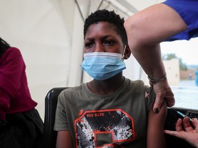 A healthcare worker administers the Pfizer COVID-19 vaccine to a boy amidst the spread of the SARS-CoV-2 variant Omicron in Johannesburg, South Africa, Dec. 4, 2021.