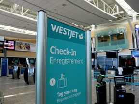 WestJet airline signage is pictured at Vancouver's airport in Richmond, B.C., Feb. 5, 2019.