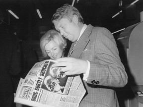 Sun founder Doug Creighton pores over the first edition of The Sunday Sun in 1973 with wife Marilyn by his side.