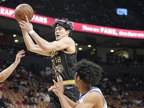 Raptors forward Yuta Watanabe (left), shown here in a game against the Warriors last week, will be one of only four from the regular roster available for today’s game against Cleveland.