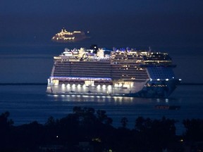 In this file photo taken on October 15, 2021, a cruise ship outside the Port of Long Beach, seen from Signal Hill, California.