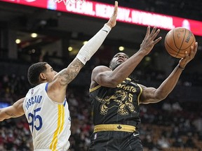 Toronto Raptors forward Precious Achiuwa shoots the ball against Golden State Warriors forward Juan Toscano-Anderson during the second half at Scotiabank Arena.