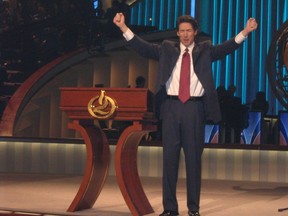 Pastor Joel Osteen delivers a sermon at Lakewood Church in Houston. The church, a converted NBA arena that seats 16,000, includes two giant TV monitors that project Osteen to congregants seated in the upper decks.