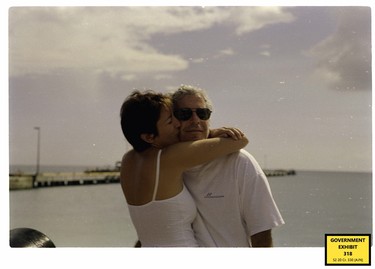 Ghislaine Maxwell kisses Jeffrey Epstein in a photo.