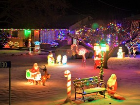 The first freshly fallen snow of the festive season reflects Christmas holiday decorations at neighbouring homes in rural Belleville, Ont., in late November.