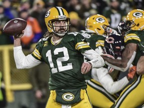 Green Bay Packers quarterback Aaron Rodgers throws a touchdown pass to wide receiver Davante Adams (not pictured) in the fourth quarter against the Chicago Bears at Lambeau Field.