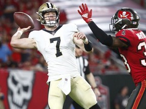 New Orleans Saints quarterback Taysom Hill throws the ball as Tampa Bay Buccaneers free safety Jordan Whitehead defends during the second half at Raymond James Stadium.