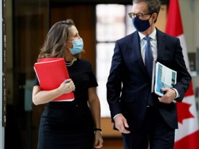 Finance Minister Chrystia Freeland and Bank of Canada Governor Tiff Macklem arrive at a news conference in Ottawa on Dec. 13, 2021.