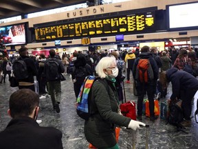 People walk through London Euston train station, amid the coronavirus disease (COVID-19) outbreak in London, Britain, December 23, 2021.