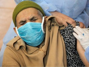 An elderly man receives the COVID-19 vaccine during a national coronavirus vaccination campaign, in Sale, Morocco January 29, 2021.