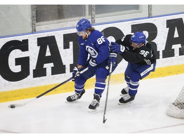 Toronto Maple Leafs William Nylander RW (88) tries a little keep away with Toronto Maple Leafs Rasmus Sandin D (38) during practice in Toronto on Friday December 31, 2021. Jack Boland/Toronto Sun/Postmedia Network