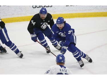 Toronto Maple Leafs Auston Matthews C (34) whales out of the corner pursued by Morgan Rielly D (44) during practice in Toronto on Friday December 31, 2021. Jack Boland/Toronto Sun/Postmedia Network