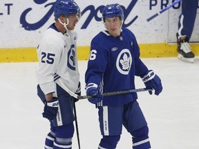 Toronto Maple Leafs Ondrej Kase (25) speaks with Mitch Marner (16) on the ice. Sixteen players were at their first practice after the Western road trip that saw COVID numbers soar  in Toronto on Sunday December 26, 2021.