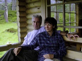 An undated photo of Jeffrey Epstein and Ghislaine Maxwell at what appears to be the Queen's log cabin at her Balmoral residence was shown in a U.S. court. The photo, believed to have been taken in 1999, was obtained in a raid at Epstein's New York home.