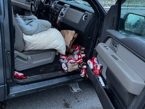 Beer cans spill out of a vehicle after a driver was stopped on Tuesday, Dec. 7, 2021 in Caledon.