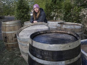 Kelsey Mostertman, winemaker and head distiller at Ripples Winery and New Wave Distilling, with oak barrels on Dec. 8 that survived the flooding.