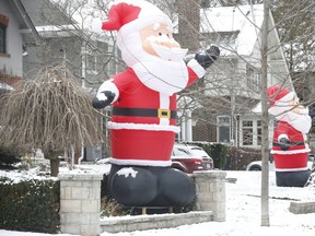About 50 inflatable Santa's can be seen on the lawns and roofs of homes on Inglewood Dr. -- or Kringlewood, as it is dubbed -- on Thursday, Dec. 9, 2021.