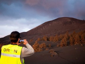 A drone pilot takes a picture of the mountain created by the eruption of the Cumbre Vieja volcano after of 89 days of its start, in the area of Las Manchas, in El Paso, on the Canary Island of La Palma, Spain, December 17, 2021.