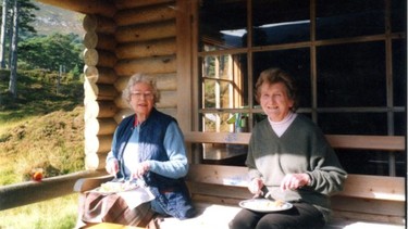 A picture of the Queen with her friend Margaret Rhodes in her log cabin in Balmoral, sitting in the same spot as Maxwell and Epstein in the previous photo, was among the photos shown in U.S. court.