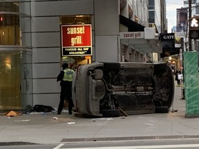 A car on its side on the sidewalk at Yonge and Richmond after a two-car crash that sent seven pedestrians to hospital.