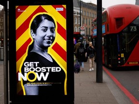A bus stop displaying a British government advertisement promoting the NHS COVID-19 vaccine booster program in London, Friday, Dec. 17, 2021.