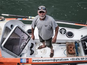 In this file photo taken on May 28, 2021 Jean-Jacques Savin poses on his rowboat at a shipyard in Lege-Cap-Ferret, southwestern France.