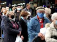 People wait in line at Olympic Stadium for their COVID-19 vaccine in Montreal, March 1, 2021.