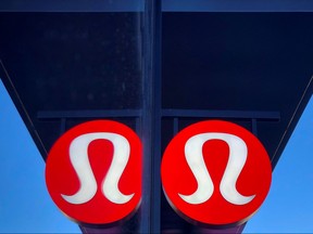 A sign for a Lululemon retail shop is reflected in the store's window at a shopping mall in San Diego, Calif., Dec. 19, 2018.