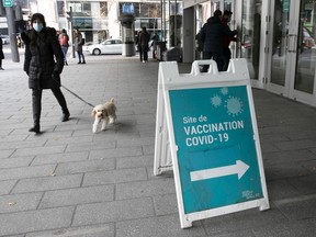 Walking the dog near the vaccination centre at the Palais des congrés on Nov. 23, 2021. (