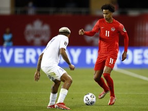 Tajon Buchanan (No. 11) of Canada dribbles the ball as Andy Najar (No. 17) of Honduras defends during a 2022 World Cup Qualifying match at BMO Field in Toronto on September 2, 2021.