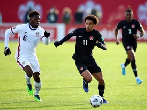 Tajon Buchanan (No. 11) of Canada and Yunus Musah (No. 6) of the United States battle for the ball during a 2022 World Cup Qualifying match at Tim Hortons Field on January 30, 2022 in Hamilton, Ontario, Canada.
