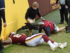 Ricky Seals-Jones of the Washington Football Team is injured after running into a camera man and then the wall during the first quarter against the Philadelphia Eagles at FedExField on Jan. 2, 2022 in Landover, Md.