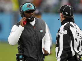 Head coach Brian Flores of the Miami Dolphins talks with line judge Mike Dolce #123 during the fourth quarter against the Tennessee Titans at Nissan Stadium on January 2, 2022 in Nashville.