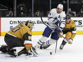 Robin Lehner #90 of the Vegas Golden Knights defends the net as Auston Matthews #34 of the Toronto Maple Leafs tries to get a shot off under pressure from Zach Whitecloud #2 of the Golden Knights in the first period last night.