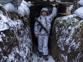 Mykola, a Ukrainian soldier with the 56th Brigade, poses for a portrait in a trench on the front line on Jan. 18, 2022 in Pisky, Ukraine.