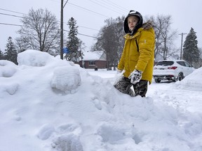 Clayton McGuire, 8, located a man who had fallen in deep snow near his house during Monday's blizzard.