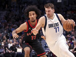 Dallas Mavericks' Luka Doncic drives to the basket as Toronto Raptors forward Justin Champagnie defends.