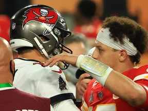 Tom Brady (left) of the Tampa Bay Buccaneers and Patrick Mahomes of the Kansas City Chiefs speak after Super Bowl LV.