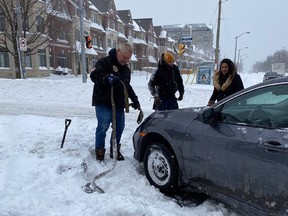 Premier Doug Ford helps dig stranded motorists out in the  Eglinton-Kipling Aves. area on Jan. 17, 2022