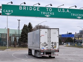 Transport trucks approach the Canada/USA border crossing in Windsor, Ont. on March 21, 2020.