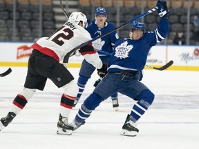 Senators defenceman Thomas Chabot (72) battles with Maple Leafs right wing Ondrej Kase earlier this season.