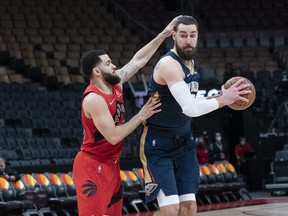 New Orleans Pelicans centre Jonas Valanciunas (17) controls the ball as Toronto Raptors guard Fred VanVleet (23) tries to defend during the third quarter at Scotiabank Arena.