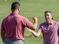 Cameron Smith (right) is congratulated by Jon Rahm (left) after Smith won on the 18th hole during the final round of the Sentry Tournament of Champions golf tournament at Kapalua Resort.