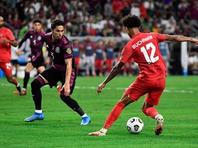 Canada's forward Tajon Buchanan(R) vies for the ball with Mexico's defender Carlos Salcedo. Reports suggest Salcedo is close to signign with TFC.