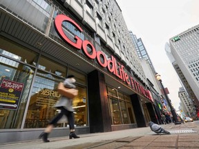 A woman walks by a closed GoodLife Fitness centre in Toronto on January 5, 2022.